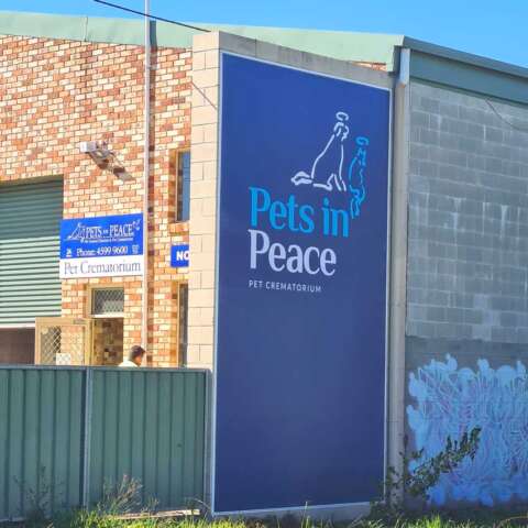 Pets in Peace wall banner printed banner material with edging has been mounted to a wall, offering long lasting signage with vibrant printed graphics